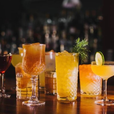 Assorted cocktails on the wood bar top at Sidecar SLO