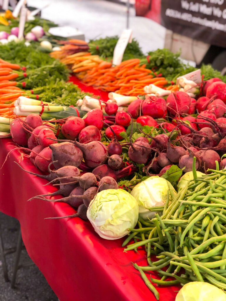 Cabbage, Beets, Turnips, Carrots, and Green Beans on a table at the Downtown SLO Farmer's Market