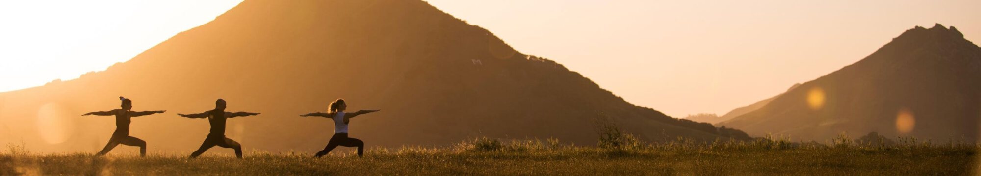 three people doing yoga at sunset in San Luis Obispo