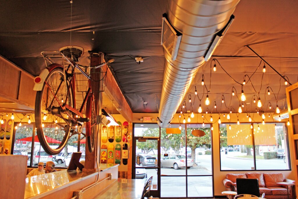 inside a san luis obispo breakfast restaurant with a bike on the ceiling