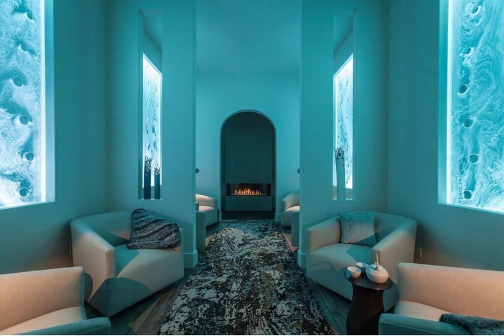 Hotel Cerro Spa's blue, high walls with couches along the sides of the hall.