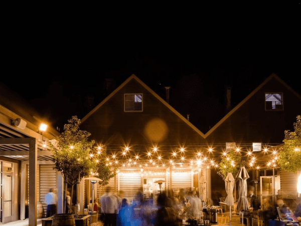 The lit patio of SLO Brew Rock in San Luis Obispo on a dark night.